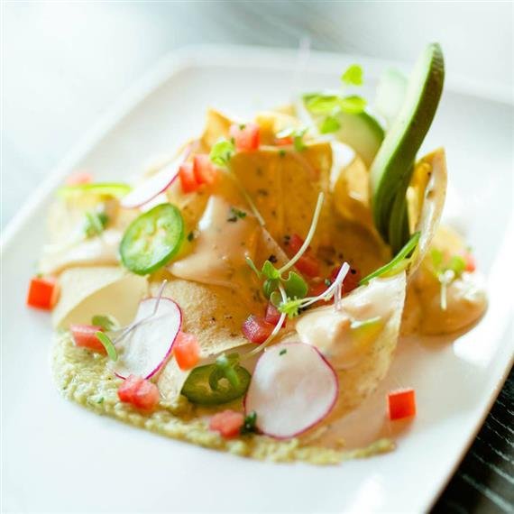 A tortilla topped with vegetables and garnish