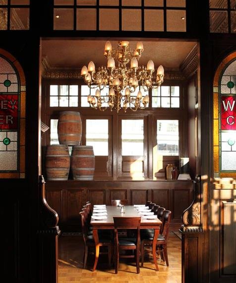 A corner in The Dublin against the window with a chandelier over a set table
